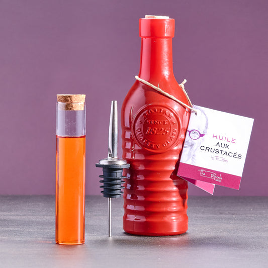 Huile culinaire bio aux crustacés dans une bouteille artisanale rouge, créée par le Chef Philippe Bellan